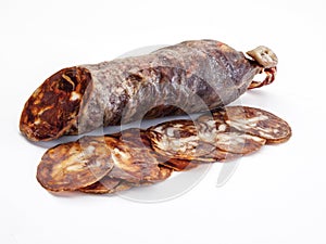 Close-up detail of a Salamanca chorizo Ã¢â¬â¹Ã¢â¬â¹with several slices of it photo